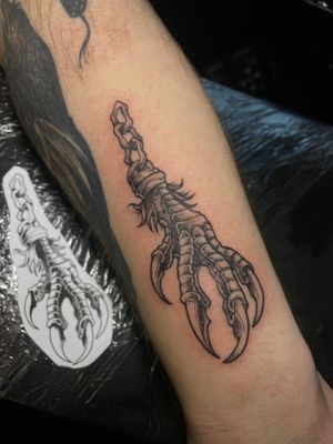 Get a fierce and unique illustrative tattoo featuring intricate claw talons and a mystical charm by the talented artist Kat Jennings.