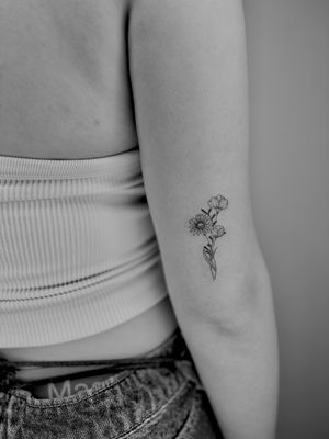 Elegant fine line tattoo featuring a beautiful bundle of flowers created by the talented artist Ruth Hall.