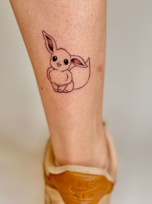 Get a stunning illustrative Pokemon Eevie tattoo by the talented artist Ruth Hall, capturing the essence of your favorite character in a unique anime style.