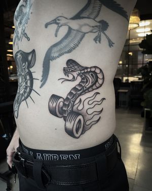 Traditional Sailor Jerry Cobra on Wheels #blackandgrey #blackandgreytattoo #traditional #traditionaltattoo #ribstattoo 