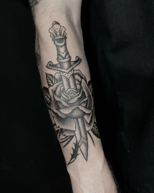 Traditional Black and Grey Rose and dagger Tattoo by Nate Fierro @natefierro #traditional #traditionaltattoo #rosetattoo #daggertattoo #forearmtattoo #blackandgrey #blackandgreytattoo