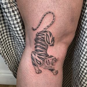 Illustrative black and gray dotwork design of a fierce tiger by the talented artist Charlie Macarthur.