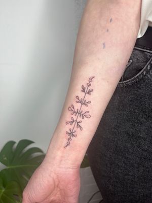 Adorn your skin with Michelle Harrison's ornamental tattoo featuring a beautifully detailed branch motif.