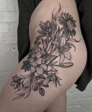 Get a beautiful and detailed floral tattoo featuring a stunning flower design done by the talented artist Claudia Smith.