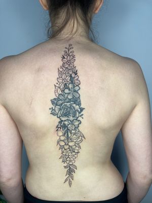Elegantly cover up with a spine flower blastover tattoo by the talented artist Michelle Harrison. Detailed and illustrative design.