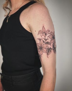Embrace the beauty of nature with this stunning lily flower tattoo. Paula's expert hand brings this floral motif to life in a unique illustrative style.