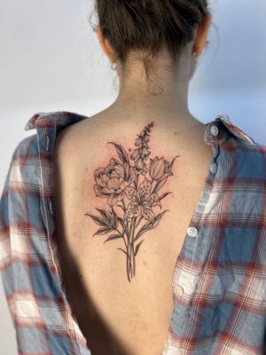 Adorn your skin with a beautiful floral bouquet tattoo created by the talented artist Paula. A stunning and timeless piece of art.