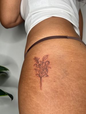 Beautifully detailed illustrative flower tattoo by Emma InkBaby, showcasing fine line mastery.