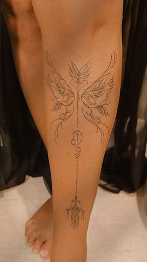 Ornamental wings and arrow on the shin