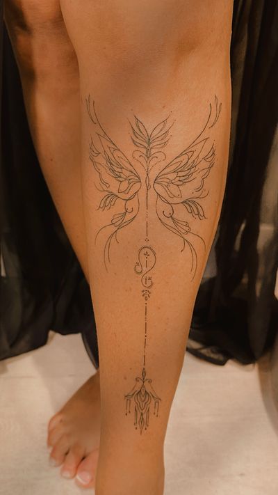 Ornamental wings and arrow on the shin