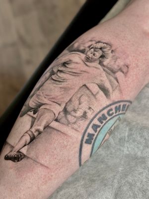 Get a striking black and gray football tattoo from Saka Tattoo, bringing your love for the sport to life with detailed illustrative design.