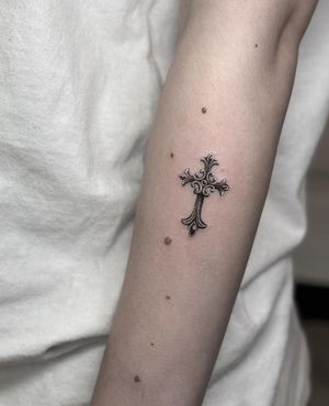 This black and gray illustrative tattoo features a stunning micro realism cross design by the talented artist HellHabits. Perfect for those seeking a unique and detailed piece of body art.
