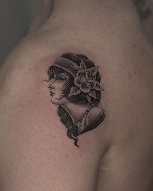 Get a classic black and gray illustrative tattoo of a woman by skilled artist HellHabits.