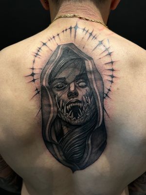This black and gray tattoo features a chilling depiction of lady death as a nun. Get inked with the perfect blend of horror and beauty at Simon Says Ink.