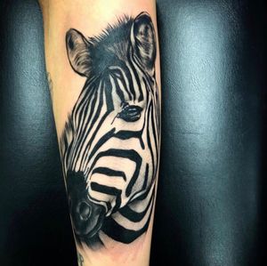 Get a stunning African zebra tattoo with lifelike details and expert shading by the talented artist at Simon Says Ink.