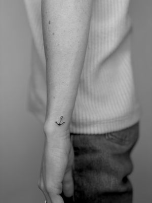 Fine line anchor tattoo by Ruth Hall, featuring a delicate and intricate design.