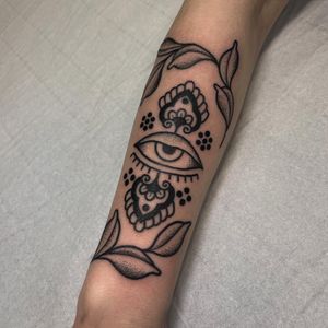 Experience the intricate beauty of blackwork and dotwork in this ornamental evil eye tattoo by Claudia Vicente. Ward off negativity with this mesmerizing design.