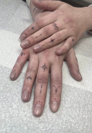 Get a dainty and intricate fine line hand-poked tattoo on your fingers by Marketa.handpoke.