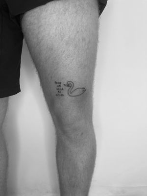 Elegant fine line and illustrative tattoo featuring a small lettering swan design. Perfect for a subtle and stylish body art statement.