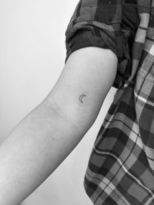 Get a beautifully detailed fine line and illustrative moon tattoo done by the talented artist Timmy.