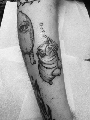Explore the depths of creativity with an illustrative tattoo by Timmy featuring a hippo in a diving mask.