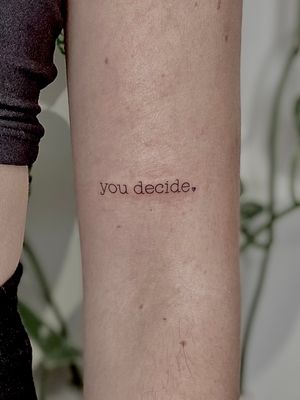 Get a stunning fine line tattoo with small lettering by the talented artist Katerina Nireta. Perfect for minimalist tattoo lovers!