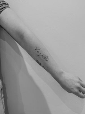Exquisite fine line and small lettering tattoo by Oliver Soames, capturing the essence of whispered dreams.