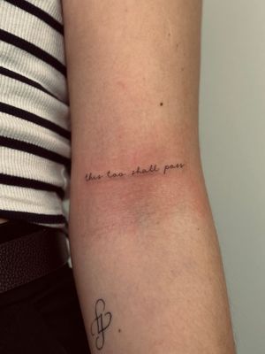 Fine line small lettering tattoo by Katerina Nireta, bringing sophistication and style to your skin. Perfect for subtle self-expression.