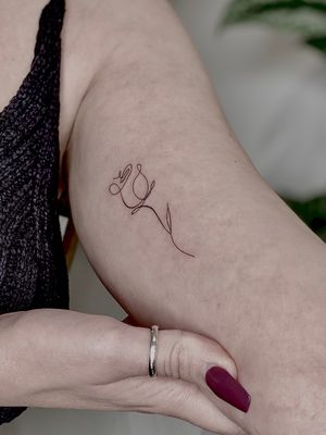 Adorn your skin with a beautifully intricate and dainty fine line rose tattoo by the talented artist Katerina Nireta.