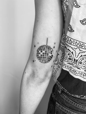 Get groovy with this black and gray disco ball tattoo done in an illustrative style by artist Timmy.