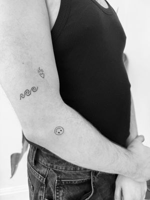 Get this cute and simple illustrative smiley face tattoo done by Timmy using fine line technique. Perfect for a minimalistic yet expressive look.