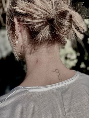 Get a fine line lightning bolt tattoo by Katerina Nireta that is both dainty and striking. Perfect for those who love subtle yet powerful ink.