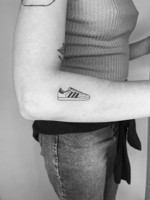 Unique illustrative tattoo of adidas sneakers designed by Timmy, showcasing your love for streetwear.