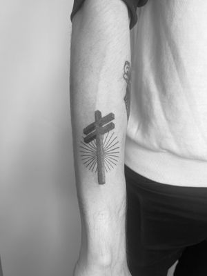 Get a unique black and gray dotwork tattoo of a cross done by the talented artist Timmy for a timeless and intricate design.