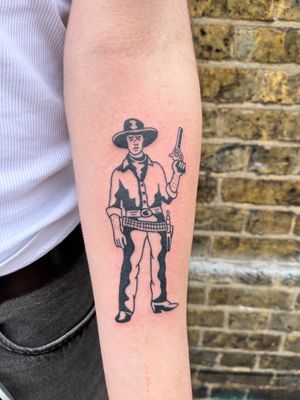 Capture the spirit of the Wild West with this illustrative cowboy tattoo by renowned artist Dave Norman.