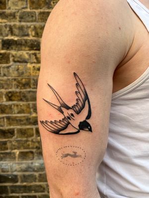 Get a stunning illustrative swallow bird tattoo by the talented artist Dave Norman. Capture the beauty of nature with this unique design.