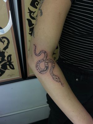 Embrace the mystique of the slithering serpent with this illustrative tattoo by the talented artist, Julia Bertholdi.