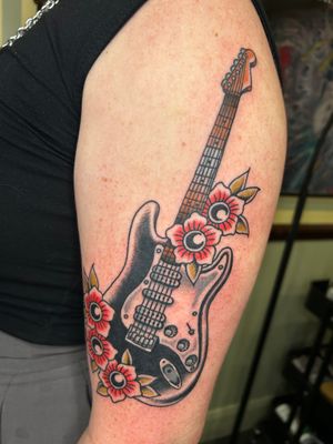 Get inked with a vibrant illustrative traditional electric guitar design by the talented artist Barney Coles.