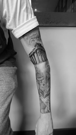 Detailed black and gray illustrative tattoo featuring ancient Greek architecture, columns, and temple design by artist Rollo.
