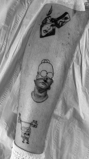Rollo's black and gray micro-realism illustration of Homer Simpson as a statue is a quirky and unique twist on traditional tattoo art.