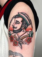 Explore the intertwining motifs of sea, sailor, tudor rose, and rope in a vibrant traditional style by Clara Colibri.