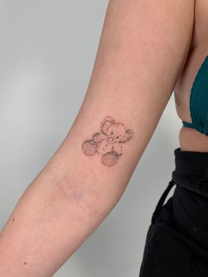 Get inked with this charming fine line illustration by Chloe Hartland, featuring a cute elephant and teddy bear motif.