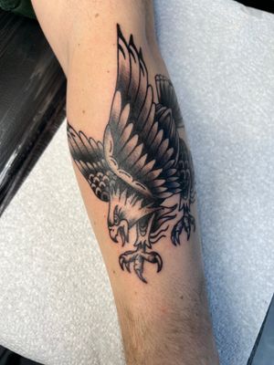 Capture the timeless beauty and strength of an eagle with this stunning traditional tattoo by Kayleigh Cole.