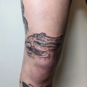 Get a unique tattoo featuring a skull and alligator design by artist Adam McDade. Perfect for bold and edgy individuals!