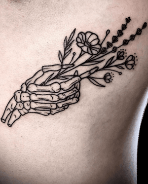 Skeleton Hand Holding Flowers