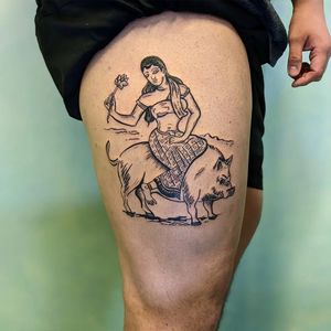 A unique illustrative tattoo featuring a woman and pig deity, created by tattoo artist Adam McDade.