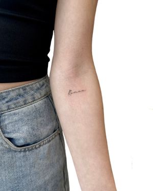Get a minimalist tattoo by Alex Lloyd with delicate fine line letters for a subtle and chic look.