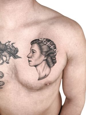 Capture the regal beauty of Queen Elizabeth II with this stunning black and gray realism tattoo by Alex Lloyd.