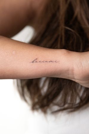Delicate fine line tattoo featuring small lettering by the talented artist Alex Lloyd.