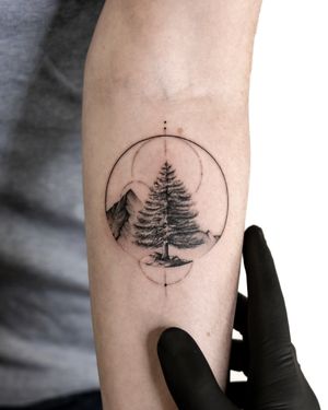Explore the beauty of fine-line micro-realism with this stunning black and gray tattoo by Alex Lloyd featuring mountains, trees, and circles.